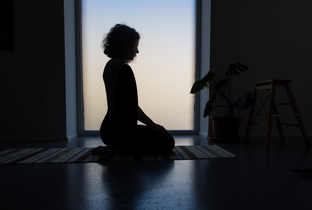 sillhouette of woman meditating