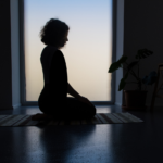 sillhouette of woman meditating