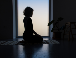 sillhouette of woman meditating